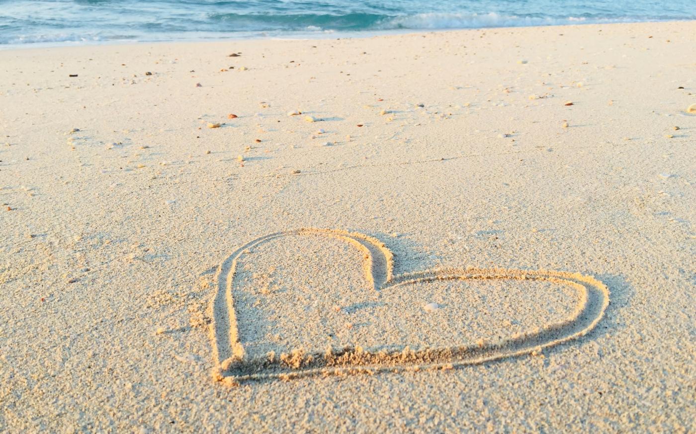 heart drawn on sand during daytime by Khadeeja Yasser courtesy of Unsplash.