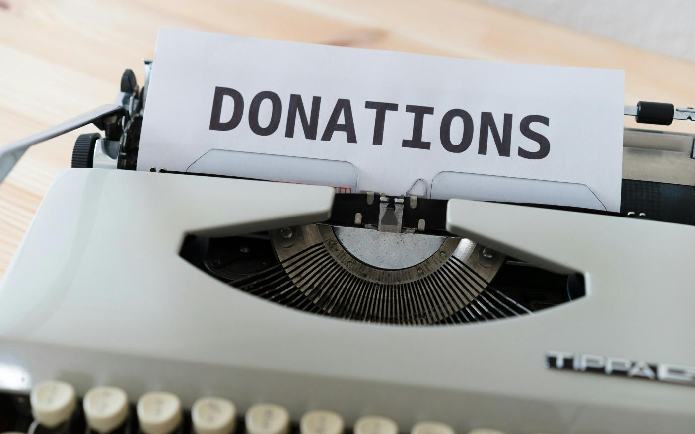 a close up of a typewriter with a donation sign on it by Markus Winkler courtesy of Unsplash.