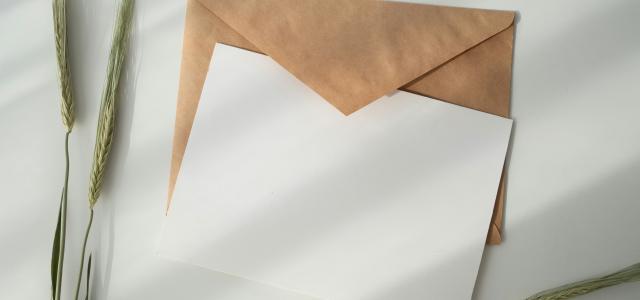 white paper and brown envelope by Kate Macate courtesy of Unsplash.